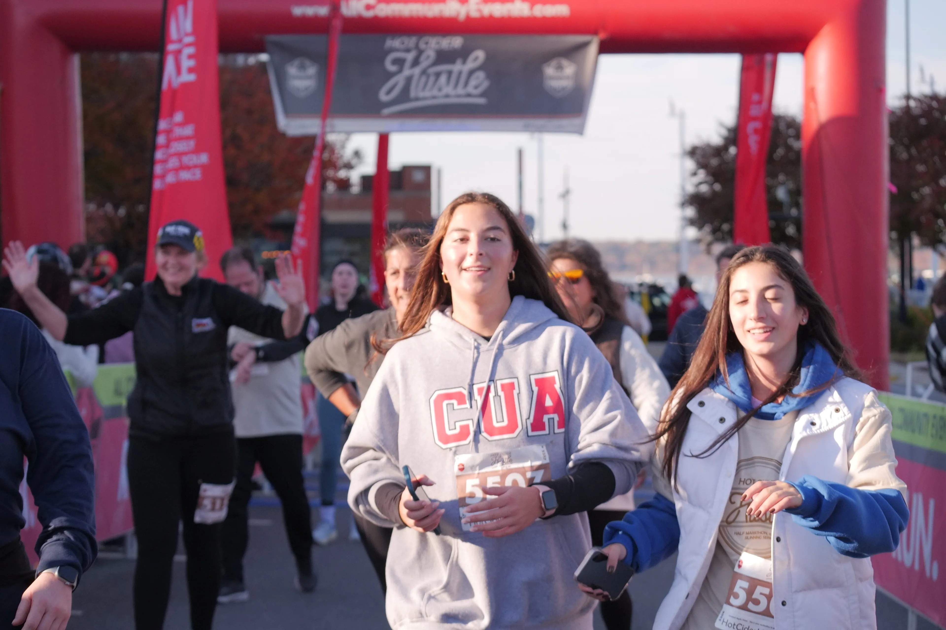 Participants crossing the finish area during an outdoor community running event in Washington, DC.