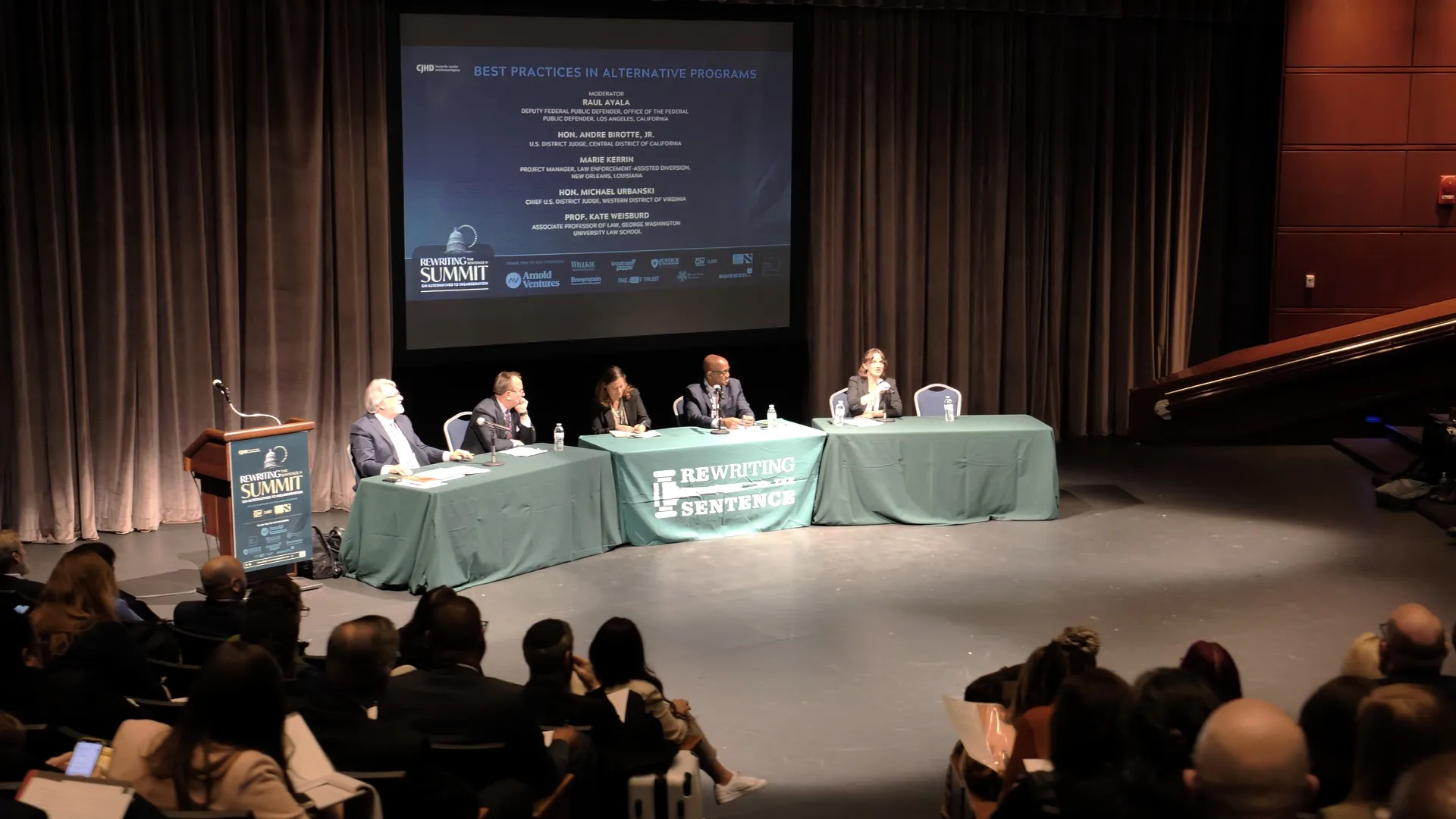 Panel of speakers addressing an audience during a professional conference in Washington, DC.