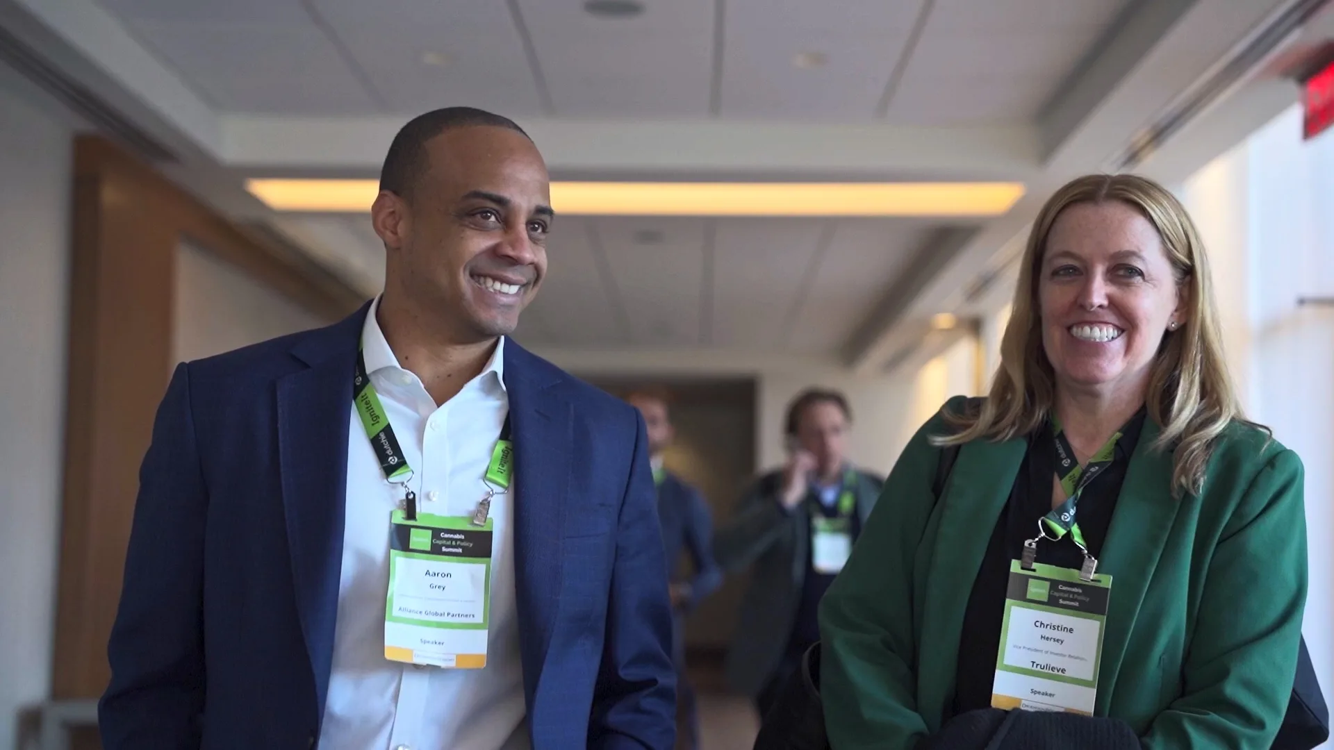 Conference speakers and attendees connecting between sessions at a professional Washington, DC event.