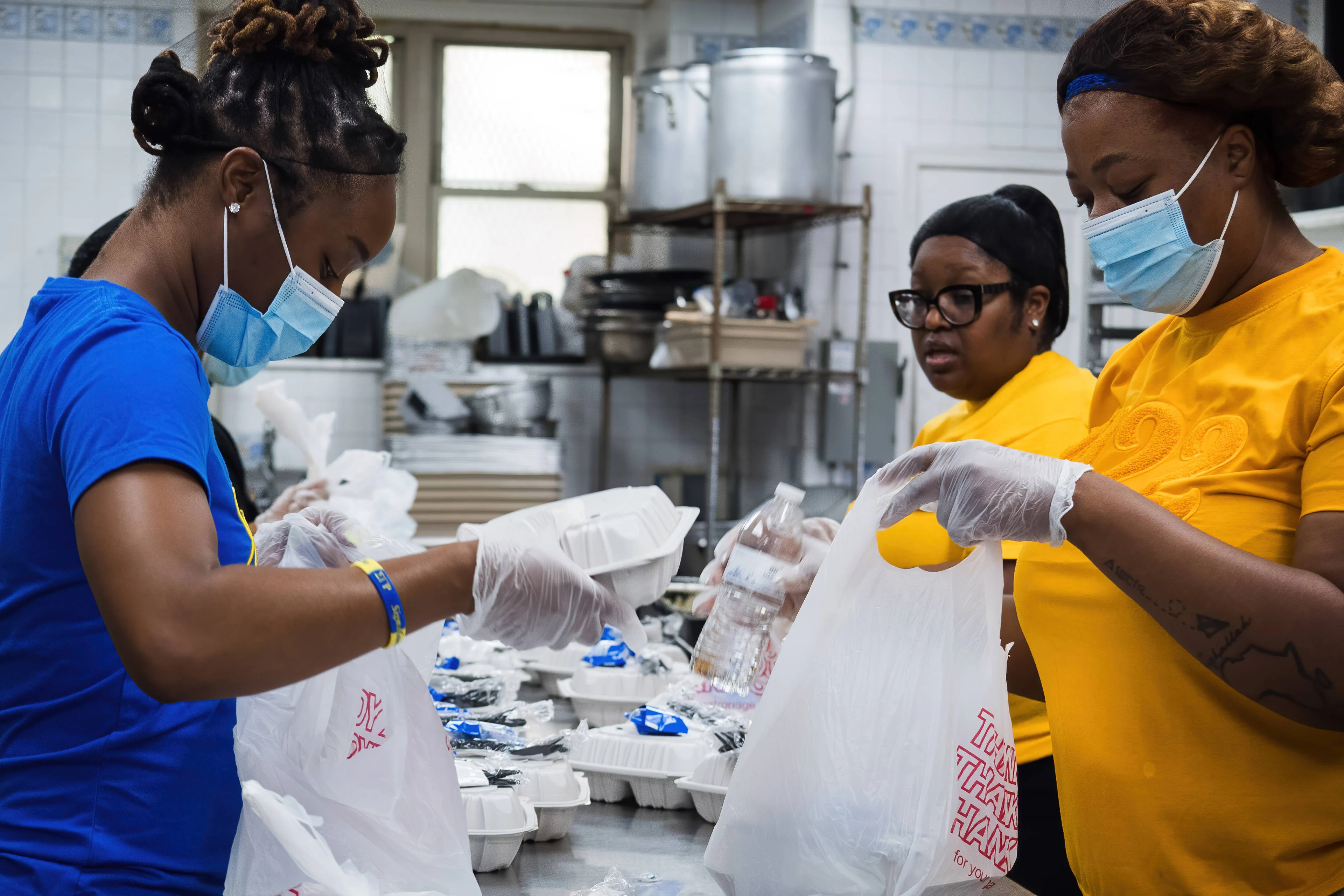 Volunteers preparing and packing meals during a nonprofit community service project in Washington, DC.