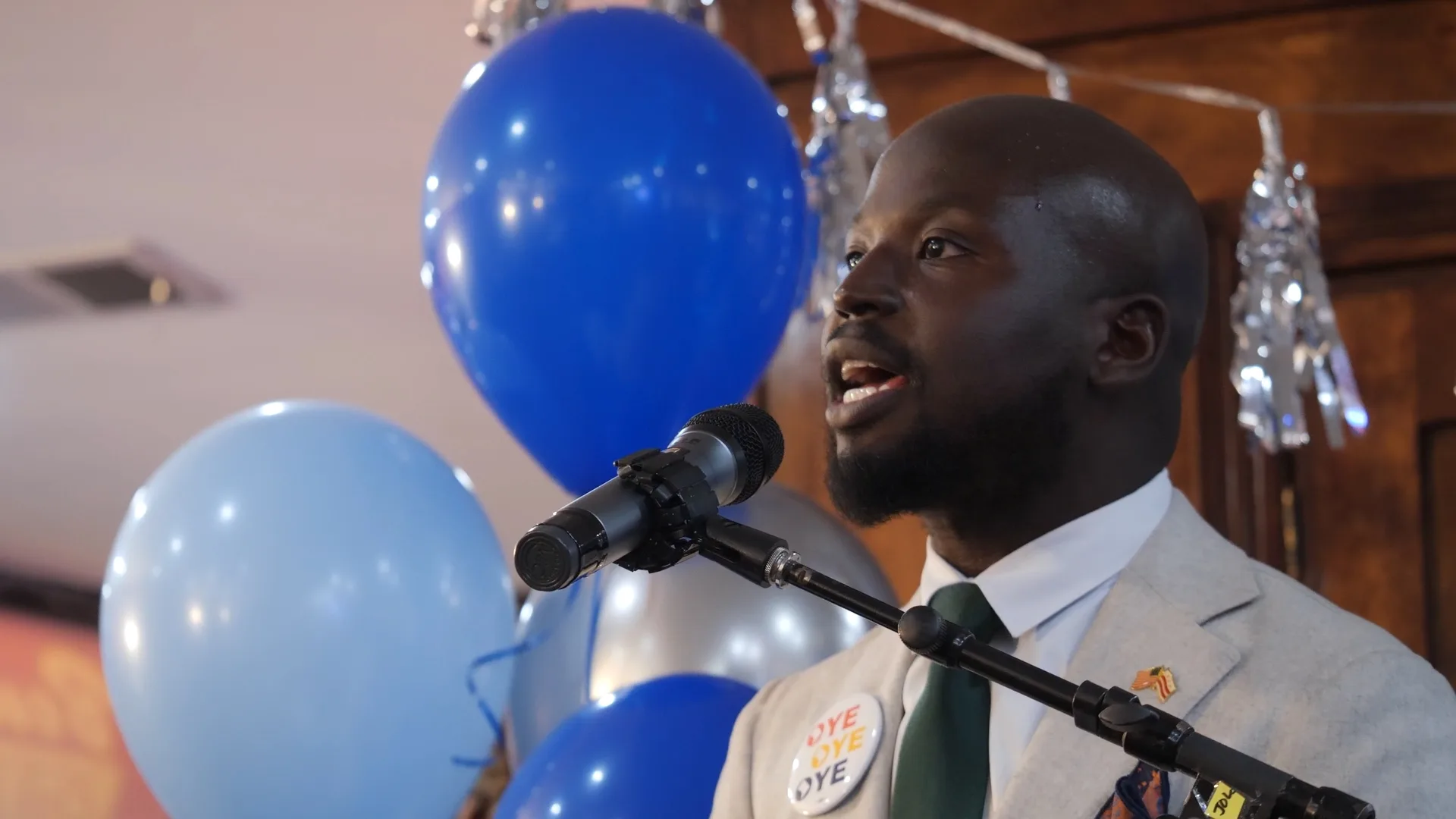 Political candidate speaking to supporters at an indoor campaign event in Washington, DC.