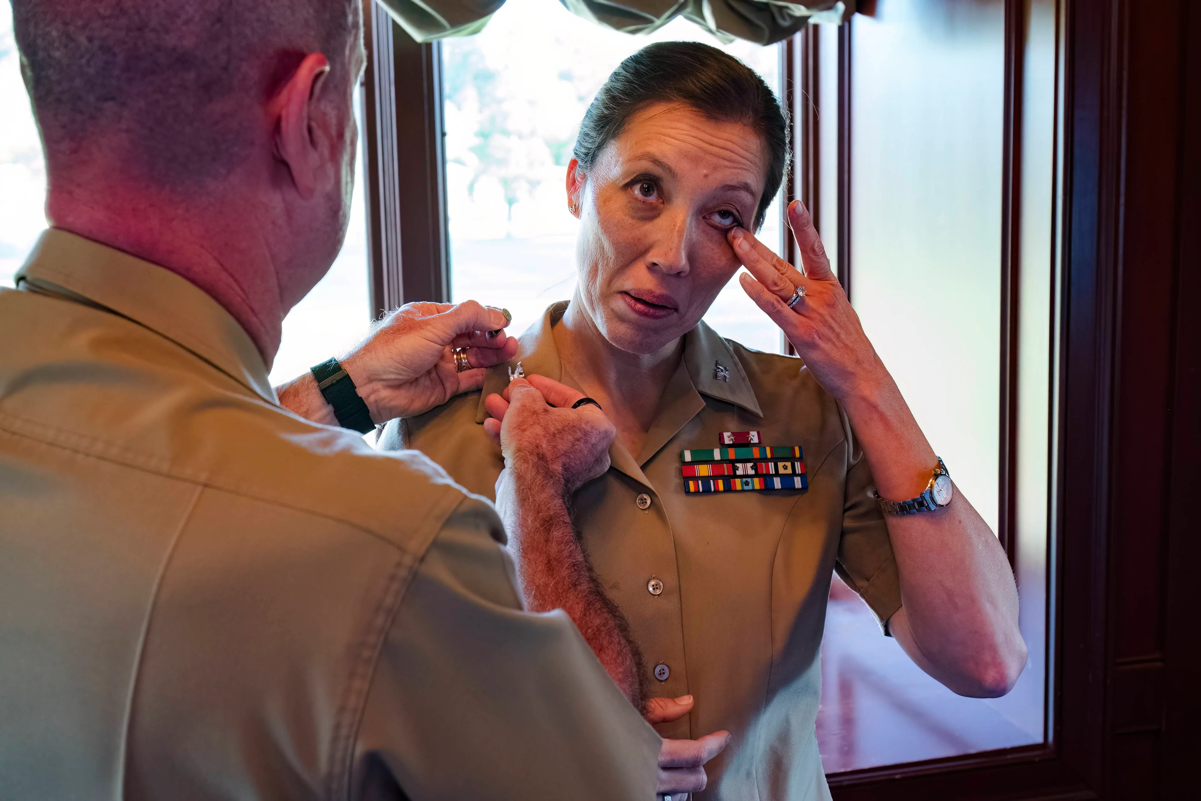 Officer receiving her new insignia during a military promotion ceremony captured by Mighty Lux Media.