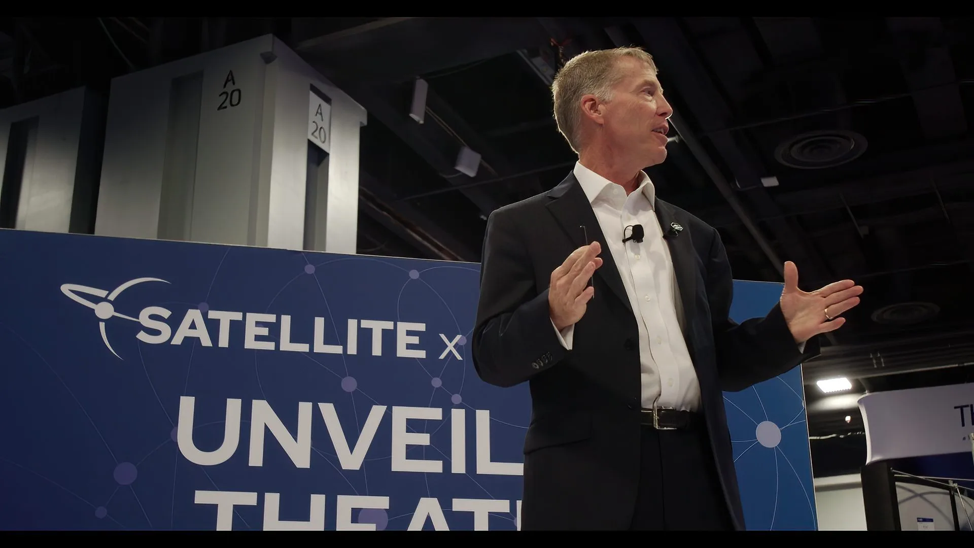 Business speaker presenting on stage during a professional trade show in Washington, DC.